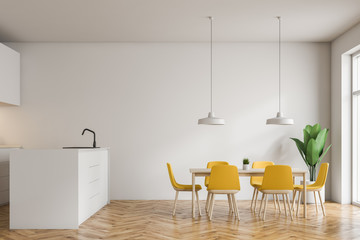 White kitchen with bar and table