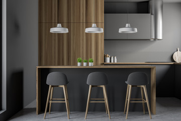 Gray and wooden kitchen interior with bar