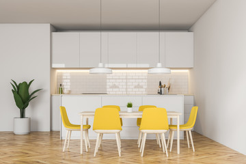 White kitchen with yellow chairs and bar