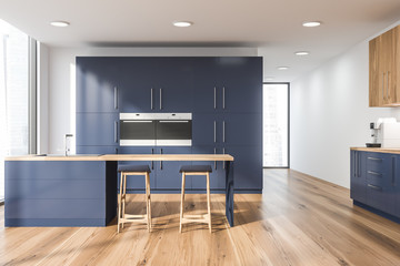 White kitchen with blue cupboard and bar