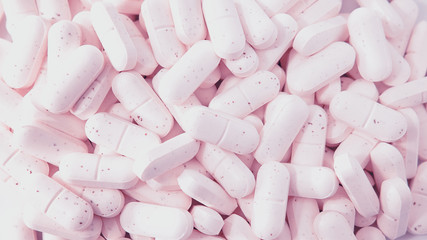 Pile of collagen supplements close-up background, an alternative protein treatment for beauty from within, based on capsule consumption for help or maintenance of skin, bones and ligaments healthy