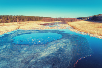 Fototapeta na wymiar Spring landscape. Aerial view of the river with remnants of ice. The ice has crashed