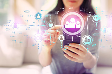Social media with woman using her smartphone in a living room