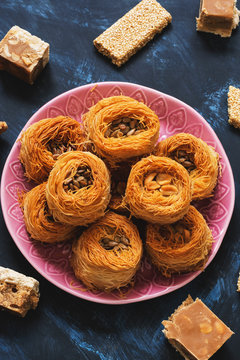 Arabic dessert baklava, sesame bars and sherbet on a blue background. Turkish Ramadan Dessert. Selective focus. Middle Eastern sweets.