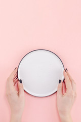 Empty plate in female hands mockup