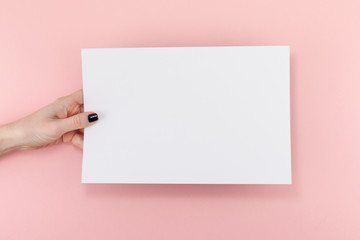 Woman hands with blank A4 paper sheet mockup
