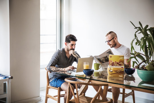 Gay couple at home having breakfast 