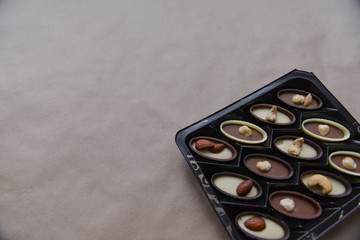 box of chocolates on kraft paper background, festive food, sweet romantic gift, confectionery
