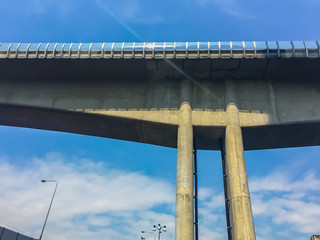 Sky train bridge structure with beam and girder under blue sky background. Railway and tollway in the city with blue sky background. Public area in Bangkok, Thailand.