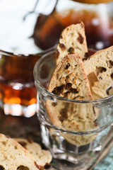 Traditional Italian sweet pastry biscotti or cantucci with raisins in glass served with drip coffee