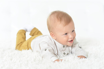Portrait of cute beautiful baby boy on a bed
