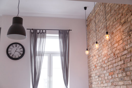 Modern interior with brick wall loft lamps