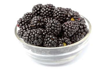BlackBerry berries in a glass bowl.