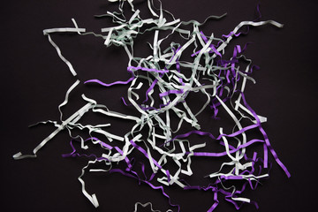 festive gift filling colored confetti on a black dark background Flat lay design