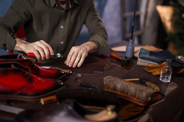 nab cutting the draft of footwear, close up cropped photo