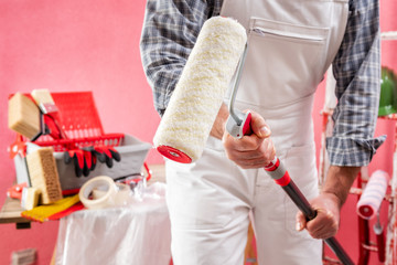 Professional house painter at work on the construction site. © francescomou