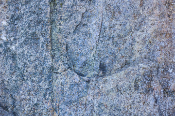 Granite texture close up. Granite rocks with porous surface. Background from solid stone. Pattern with natural material