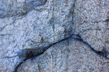 Granite texture close up. Granite rocks with porous surface. Background from solid stone. Pattern with natural material
