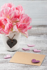 Fresh pink tulip flowers and envelope