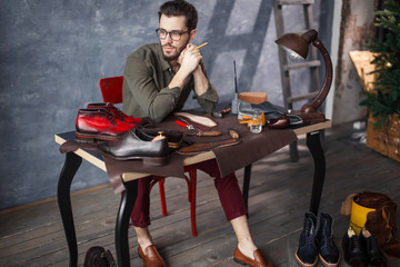 shoemaker is waiting for the ending of working day. full length side view photo