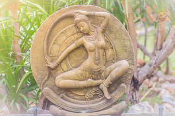 Thai mother earth (Phra Mae Thorani) fountain statue at the public park. She is the goddess that...