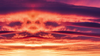 Face in the sky in the red clouds.