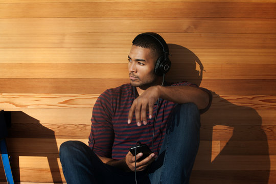 Young man listening to music on headphones