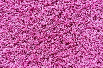 Тexture of a magenta carpet with a large nap.