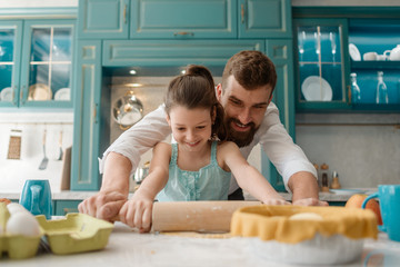Daddy and daughter prepare dough