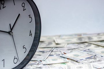 One hundred dollar bills and a white big clock, concept, time is money background