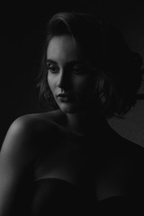 Fototapeta premium Black and white portrait of lovely brunette woman with naked shoulders