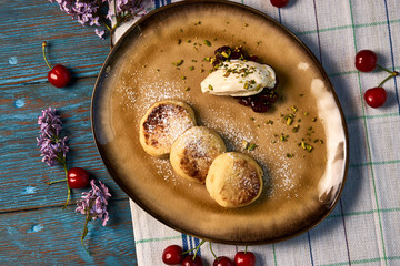 Homemade Cottage cheese pancakes, syrniki on rustic wooden table, close-up
