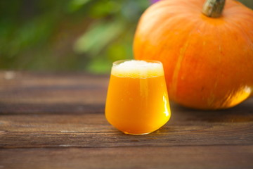 glass of pumpkin juice on  wooden background