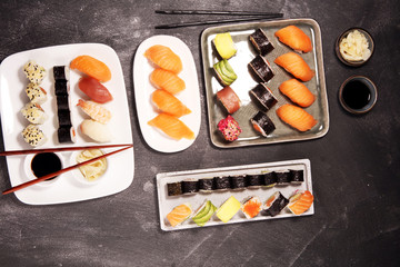 close up of sashimi sushi set with chopsticks and soy - sushi roll with salmon and sushi roll with smoked eel