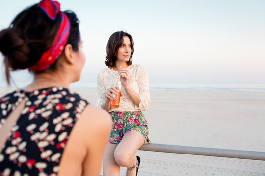 Woman drinking soda at beach 