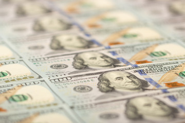 Blurred background full of 100 us dollars. Business and finance. selective focus.