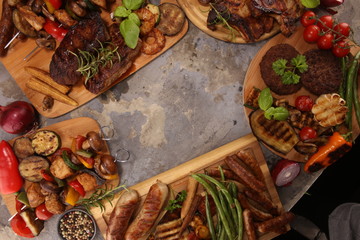 Assorted delicious grilled meat with vegetable on rustic table
