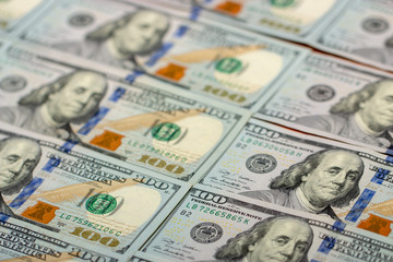 Blurred background full of 100 us dollars. Business and finance. selective focus.