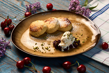 Homemade Cottage cheese pancakes, syrniki on rustic wooden table, close-up