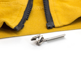 Broken zipper on yellow shirt jacket. Detail close-up photo