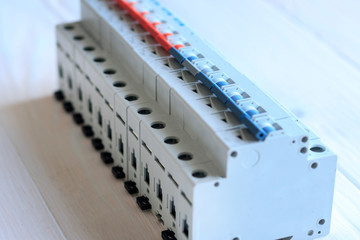 wooden background. on it in a row are automatic switches for opening the electric circuit.