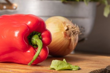 Detail shot of raw vegetables. Morrón, onion, lettuce, tomato. Colors and textures of vegetables.