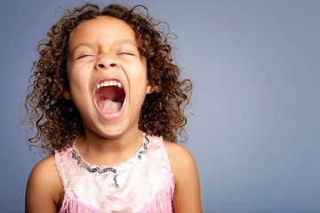 Studio portrait of girl (6-7) yelling 
