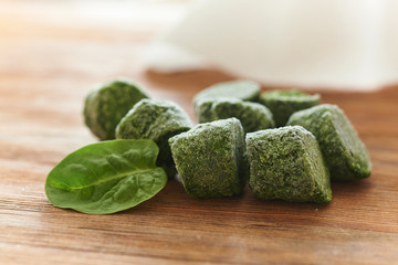 frozen spinach on wooden background