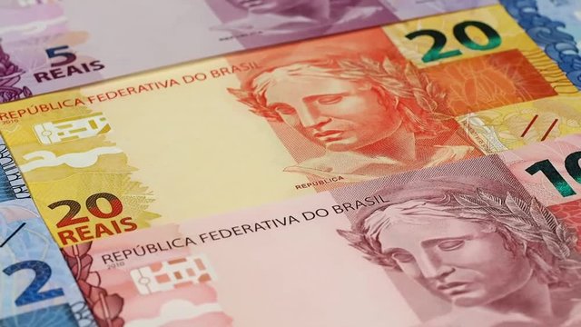 Brazil real notes slow rotating. Brazilian money, currency. Low angle. Stock video footage