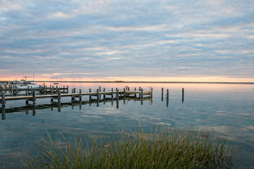 Pier at sunset, dock, boating, sailing, sea, ocean view, calming, grass, blue, colorful, horizon, clouds, horizontal image