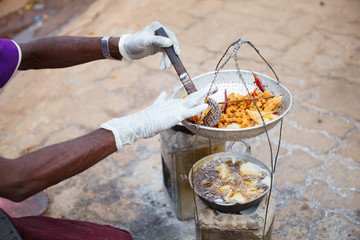 Traditional Burmese street food cuisine, crispy crunchy deep fried garlic wheat flour stuffed with...