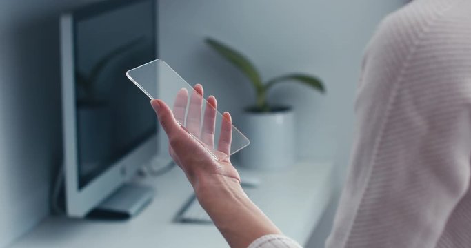 CU Caucasian female using futuristic transparent phone, no interface added, easy tracking. 4K UHD