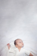 Vertical photo of newborn baby boy with copy space