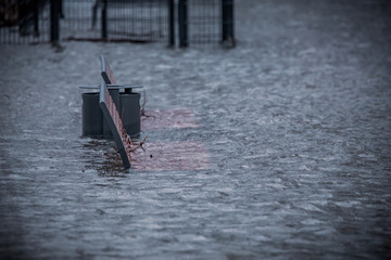 Climate damage. Climate change. Rhine flood in Cologne and Bonn. Park benches are in the water